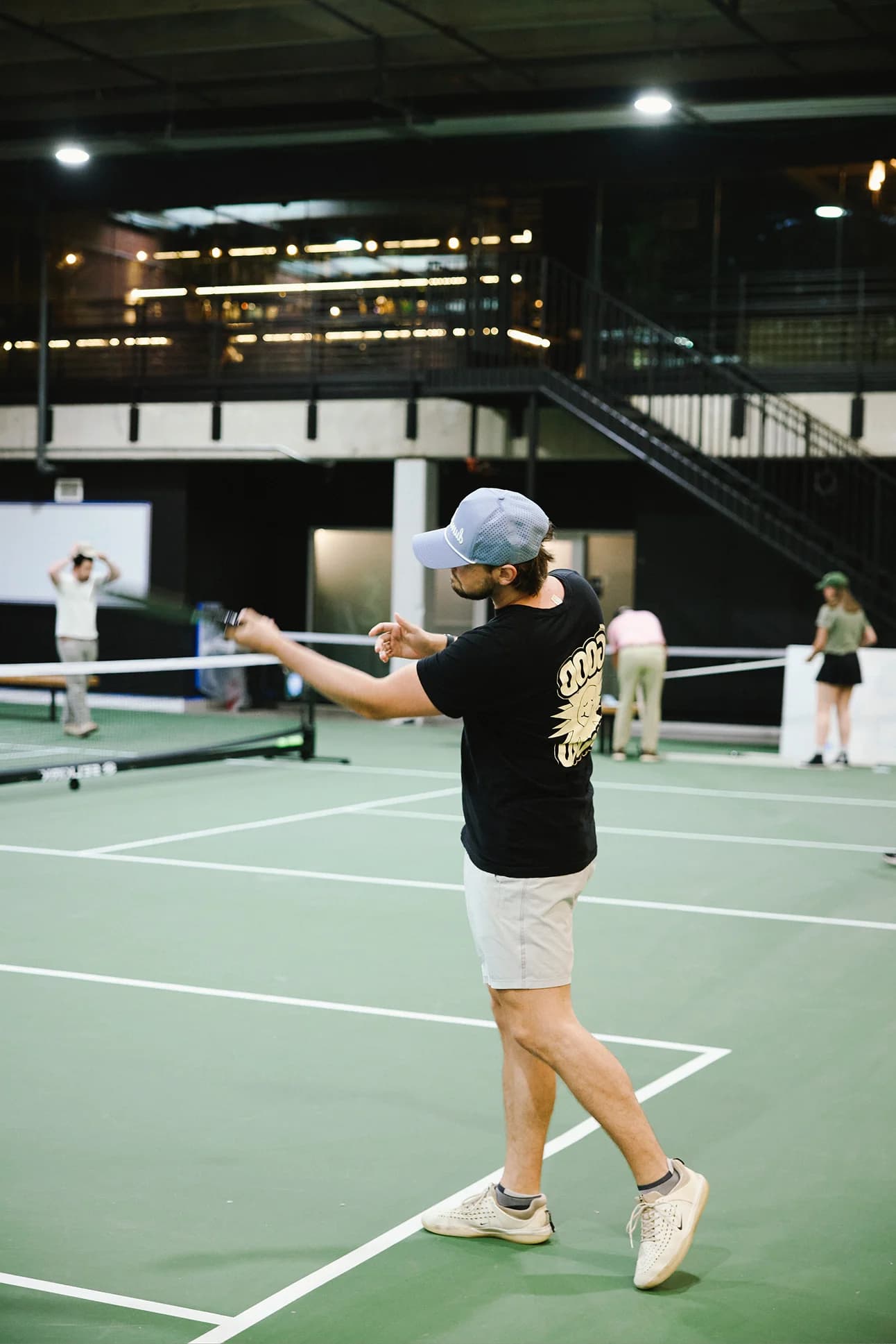 Tournament match action under professional anti-glare court lighting