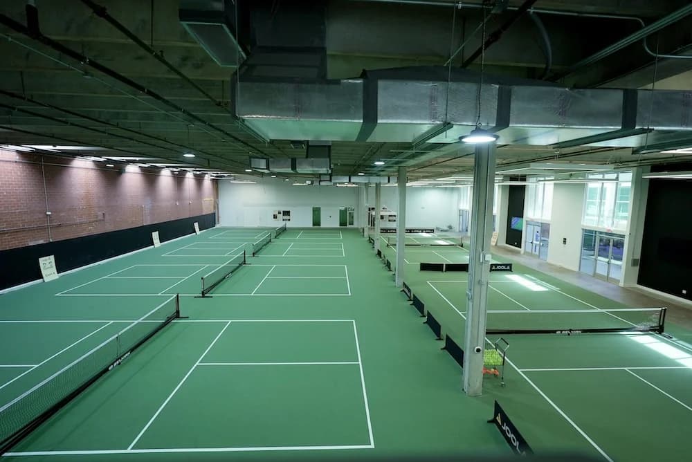 Dedicated pickleball drill session on cushioned indoor surface